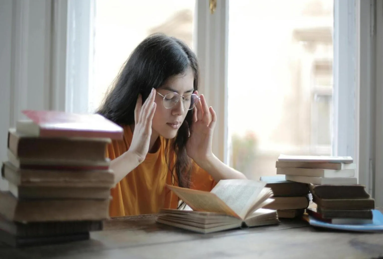 A student reading a book inside the library