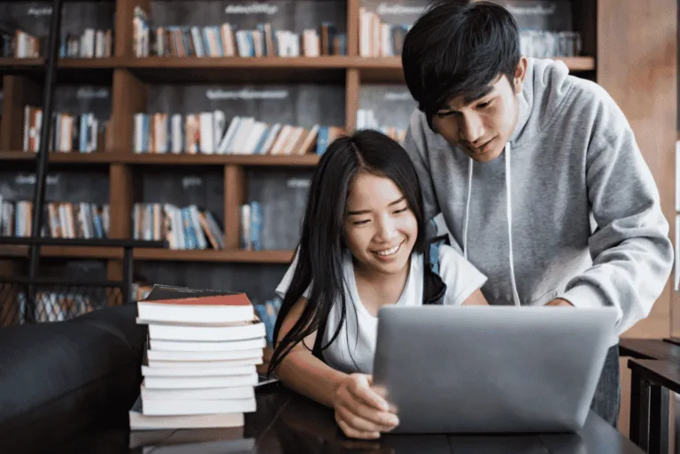Two people looking at a laptop together.