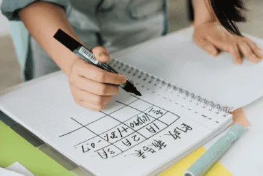 Student solving maths equations with handwritten notes for TI-Nspire CAS tips