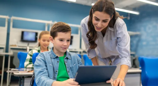 Tutor helping a student with personalised digital learning